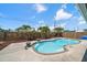 Relaxing pool area featuring a sparkling pool, concrete surround, and privacy fence at 3831 Yardley N Ave, St Petersburg, FL 33713