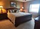 Traditional bedroom with a large bed, wooden furniture, carpet flooring, and neutral wall color at 400 64Th Ave # 1105, St Pete Beach, FL 33706