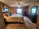 Inviting bedroom featuring a queen-sized bed, window view, and dark wood furniture at 400 64Th Ave # 1105, St Pete Beach, FL 33706