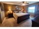 Comfortable bedroom featuring a large bed, warm lighting, and a window with a view at 400 64Th Ave # 1105, St Pete Beach, FL 33706