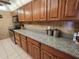 Kitchen featuring wood cabinets, gray countertops, and stainless steel appliances at 400 64Th Ave # 1105, St Pete Beach, FL 33706