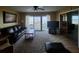 Bright living room with balcony offering serene water views and comfortable seating at 400 64Th Ave # 1105, St Pete Beach, FL 33706