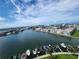 Beautiful waterfront view showcasing boats docked along the channel, buildings, and clear blue skies at 400 64Th Ave # 1105, St Pete Beach, FL 33706