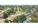 An aerial view of a residential neighborhood with tree-lined streets and well-maintained homes and some with in-ground pools at 4111 Whiting Se Dr, St Petersburg, FL 33705