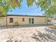 The rear elevation of the home shows the solar panels, sliding glass doors to the paver patio, and a generous backyard at 4111 Whiting Se Dr, St Petersburg, FL 33705