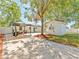 A spacious backyard features a seating area under a gazebo, a storage shed, and the rear of the home at 4111 Whiting Se Dr, St Petersburg, FL 33705