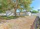 A generous backyard is shown here, featuring a white fence, storage shed, and the home's rear elevation at 4111 Whiting Se Dr, St Petersburg, FL 33705