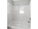 This bright bathroom features a window and tiled shower-tub combo at 4111 Whiting Se Dr, St Petersburg, FL 33705
