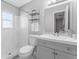 Updated bathroom with a gray vanity and a tiled shower at 4111 Whiting Se Dr, St Petersburg, FL 33705