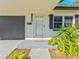 Inviting home exterior featuring well-maintained landscaping, modern address numbers, and a sleek, attached garage at 4111 Whiting Se Dr, St Petersburg, FL 33705