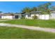 Charming single-story home with lush green lawn and white picket fence bordering the property lines at 4111 Whiting Se Dr, St Petersburg, FL 33705