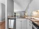 Bright kitchen featuring granite countertops, stainless steel appliances, and white cabinets at 4111 Whiting Se Dr, St Petersburg, FL 33705