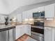Well-equipped kitchen boasts stainless steel appliances, granite countertops, and ample cabinet space for storage at 4111 Whiting Se Dr, St Petersburg, FL 33705