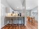 Modern kitchen with breakfast bar seating, white cabinets, stainless steel appliances, and open to the dining area at 4111 Whiting Se Dr, St Petersburg, FL 33705