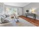 Cozy living room with wood-look flooring, soft lighting, comfortable seating, and a serene atmosphere at 4111 Whiting Se Dr, St Petersburg, FL 33705
