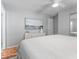Bright main bedroom featuring a ceiling fan, a dresser, and a large window at 4111 Whiting Se Dr, St Petersburg, FL 33705