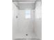 Clean white tiled shower with a window at 4111 Whiting Se Dr, St Petersburg, FL 33705