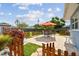 Spacious backyard featuring a brick patio with an umbrella-covered table, surrounded by lush landscaping at 4211 28Th N Ave, St Petersburg, FL 33713