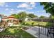 Well-maintained backyard with a patio set, lush lawn, mature trees, and a charming privacy fence at 4211 28Th N Ave, St Petersburg, FL 33713