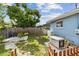 Secluded backyard with a grassy area, patio with chairs, privacy fence, and a home generator at 4211 28Th N Ave, St Petersburg, FL 33713