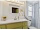 Bathroom with yellow sink, towel holder, and accent colors, plus a blue patterned shower curtain at 4211 28Th N Ave, St Petersburg, FL 33713