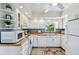 Well-lit kitchen featuring white cabinetry, functional appliances, and a cozy design at 4211 28Th N Ave, St Petersburg, FL 33713