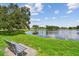 Picturesque lake view from a grassy shoreline with a bench, perfect for relaxation and enjoying nature at 4211 28Th N Ave, St Petersburg, FL 33713