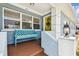 Inviting covered porch with a colorful bench and decorative details at 4211 28Th N Ave, St Petersburg, FL 33713