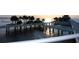 Scenic waterfront view of a pier extending into the ocean, with palm trees and sunset hues at 4211 28Th N Ave, St Petersburg, FL 33713