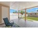 Relaxing screened-in back porch overlooking the fenced backyard at 4414 W Hanna Ave, Tampa, FL 33614