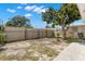 Open backyard with partial fencing and large shade tree at 4414 W Hanna Ave, Tampa, FL 33614