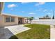 Large backyard featuring a well-maintained lawn, concrete patio, and a newly installed fence at 4414 W Hanna Ave, Tampa, FL 33614