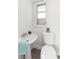 Small half bath with pedestal sink, toilet and window with natural light at 4414 W Hanna Ave, Tampa, FL 33614