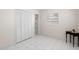 Bedroom featuring tile floors, closet, window and adjacent bathroom at 4414 W Hanna Ave, Tampa, FL 33614