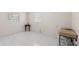 Bright bedroom with tile floors, two windows, and a small table at 4414 W Hanna Ave, Tampa, FL 33614