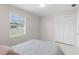 Bedroom with a closet, window, and white tile floors at 4414 W Hanna Ave, Tampa, FL 33614
