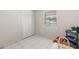 Bedroom with a closet, window, and white tile floors at 4414 W Hanna Ave, Tampa, FL 33614