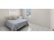 Bright bedroom with white tile floors and a comfortable bed at 4414 W Hanna Ave, Tampa, FL 33614