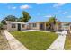 Wide backyard with a shed and tropical landscaping at 4414 W Hanna Ave, Tampa, FL 33614