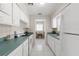 Bright kitchen features white cabinetry and tiled floors at 4414 W Hanna Ave, Tampa, FL 33614