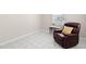 Living room with a comfortable recliner, tile flooring, and natural light at 4414 W Hanna Ave, Tampa, FL 33614