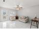 Bright living room featuring tile floors, large windows and a ceiling fan at 4414 W Hanna Ave, Tampa, FL 33614
