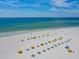 A scenic beach with lounge chairs and sunshades overlooking tranquil turquoise waters at 505 67Th Ave # 11, St Pete Beach, FL 33706
