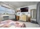 Cozy bedroom featuring a flat screen TV, window, and charming vintage-style decor with light and bright accents at 505 67Th Ave # 11, St Pete Beach, FL 33706