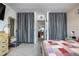 Bedroom view with neutral-toned curtains, stylish storage trunk, and a comfortable bed featuring patchwork quilt at 505 67Th Ave # 11, St Pete Beach, FL 33706