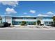 Inviting two-story complex showcasing a serene blue facade, decorative railings and convenient parking at 505 67Th Ave # 11, St Pete Beach, FL 33706
