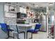 Charming kitchen featuring open shelving, stainless steel appliances, and a cozy breakfast bar at 505 67Th Ave # 11, St Pete Beach, FL 33706