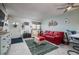 Inviting living room with a cozy red couch, stylish decor, and seamless flow to the entryway at 505 67Th Ave # 11, St Pete Beach, FL 33706