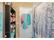 A simple bathroom featuring a shower with a winter-themed curtain and open storage shelves at 5501 67Th N Ave # 11, Pinellas Park, FL 33781
