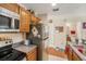 Efficient kitchen design with essential appliances and a view of an adjacent bathroom at 5501 67Th N Ave # 11, Pinellas Park, FL 33781